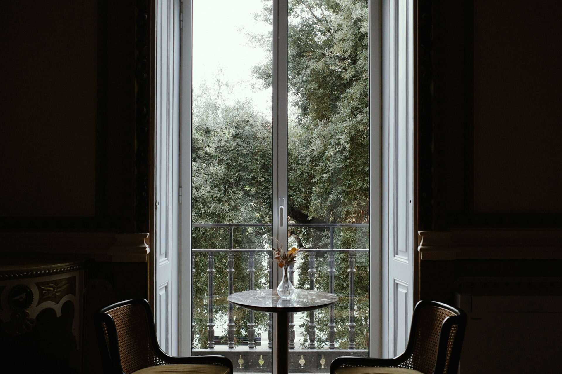 Two chairs and a table by a large window