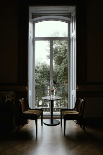 Two chairs and a table by a large window